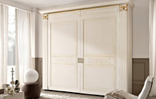 wardrobe with flush doors with top section cornice, antique white glazed finish with ochre decorations and gold details